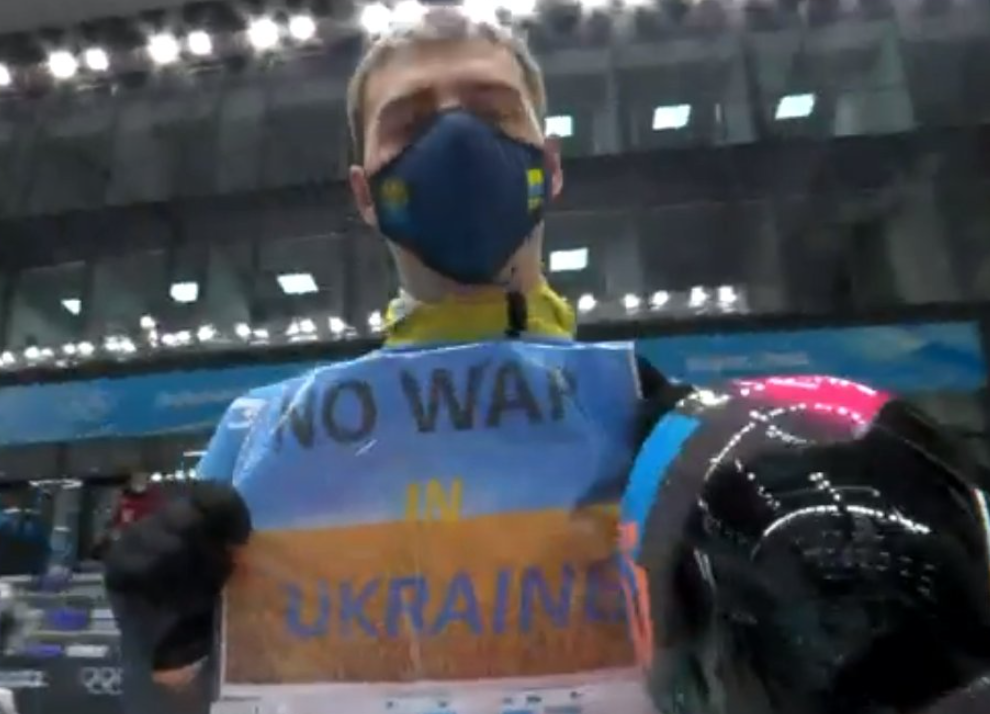 Ukraine&#39;s Vladyslav Heraskevych holds up a sign reading &#39;No war in Ukraine&#39; after completing his third un in the men&#39;s skeleton at the Beijing Olympics. (NBC screenshot)