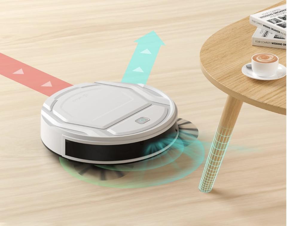 the amazon Lefant Robot Vacuum Cleaner on hardwood floor near a table