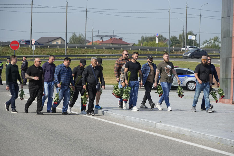 People walk to attend a farewell ceremony for Dmitry Utkin, who oversaw Wagner Group's military operations, at Federal Military Memorial Cemetery in Mytishchy, outside Moscow, Russia, Thursday, Aug. 31, 2023. Utkin, whose military call sign Wagner gave the name to the group, is presumed to have died in a plane crash along with Wagner's owner Yevgeny Prigozhin and other military company's officers. (AP Photo/Alexander Zemlianichenko)