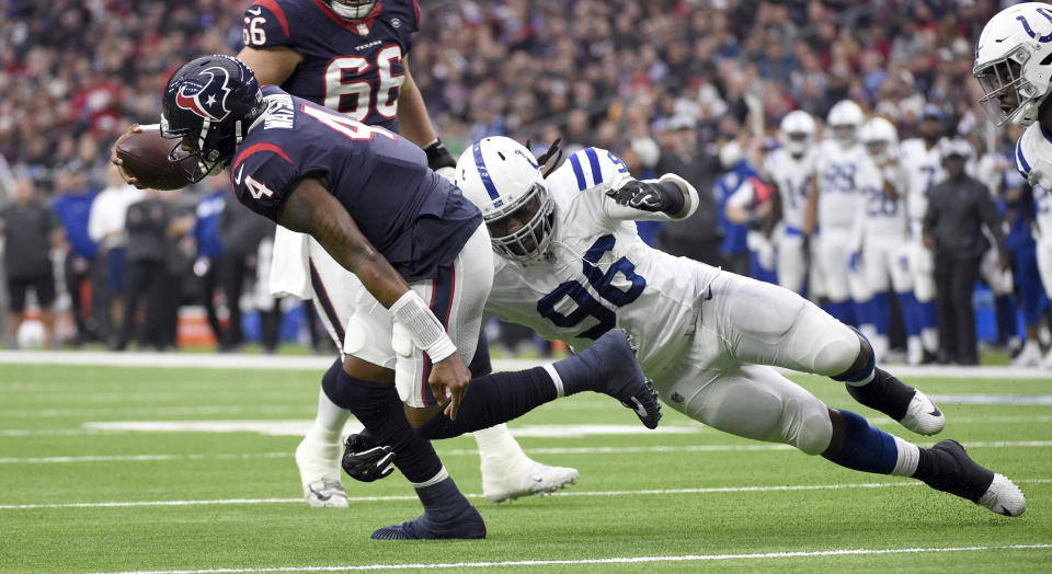 Houston Texans quarterback Deshaun Watson (4) is tackled by Indianapolis Colts defensive tackle Denico Autry (96) during the first half of an NFL football game Sunday, Dec. 9, 2018, in Houston. (AP Photo/Eric Christian Smith)