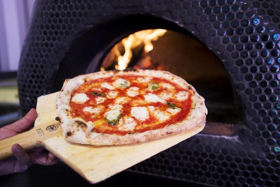 A margherita pizza is removed from the wood-fired oven at the Federalist Public House, in the alley between N and 20th streets.