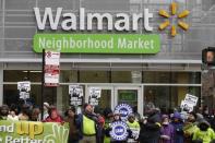 People demonstrate for higher wages and better working conditions, outside of a Walmart during Black Friday shopping in Chicago November 28, 2014. REUTERS/Andrew Nelles