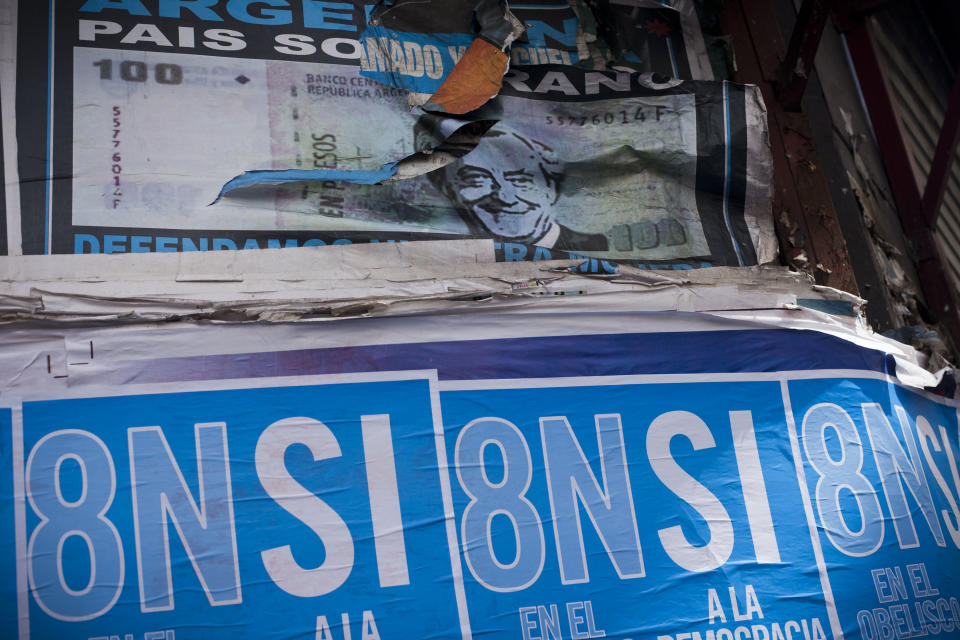 A poster with a photo of Argentina's late President Nestor Kirchner, top, is partially covered by posters promoting an anti-government march in Buenos Aires, Argentina, Wednesday, Nov. 7, 2012. People are using social networks instead of political parties to mobilize a massive march for Thursday against the leadership of Argentina's President Cristina Fernandez, mobilizing what they hope will be the largest anti-government protest the country has seen in more than a decade. The poster reads in Spanish "Yes to democracy, no to re-election." (AP Photo/Victor R. Caivano)