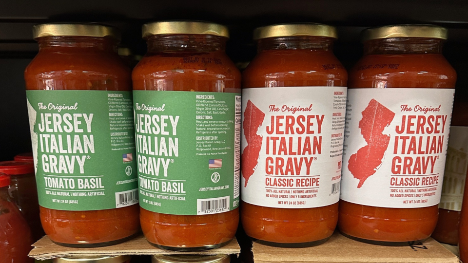 bottles of tomato sauce lined up on a shelf