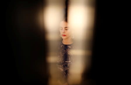 A model gets her make-up adjusted as she attends the Spring/Summer 2020 women's ready-to-wear collection presentation for fashion house Patou during Paris Fashion Week in Paris