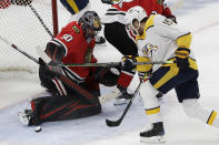 Chicago Blackhawks goalie Corey Crawford, left, blocks a shot by Nashville Predators center Calle Jarnkrok (19) during the second period of an NHL hockey game in Chicago, Friday, Feb. 21, 2020. (AP Photo/Nam Y. Huh)