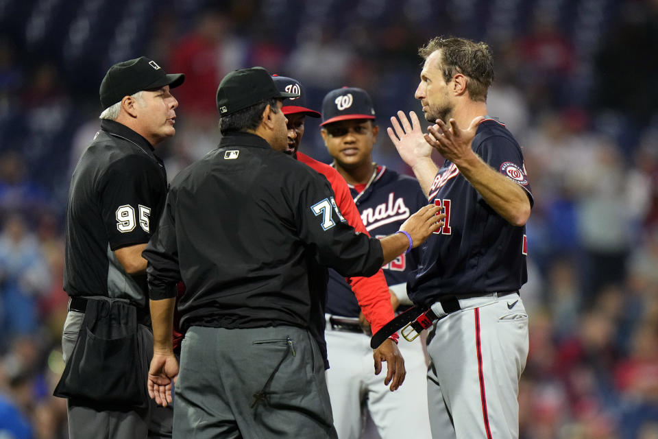 Washington Nationals pitcher Max Scherzer, right, is checked for foreign substances during the middle of the fourth inning of a baseball game against the Philadelphia Phillies, Tuesday, June 22, 2021, in Philadelphia. (AP Photo/Matt Slocum)