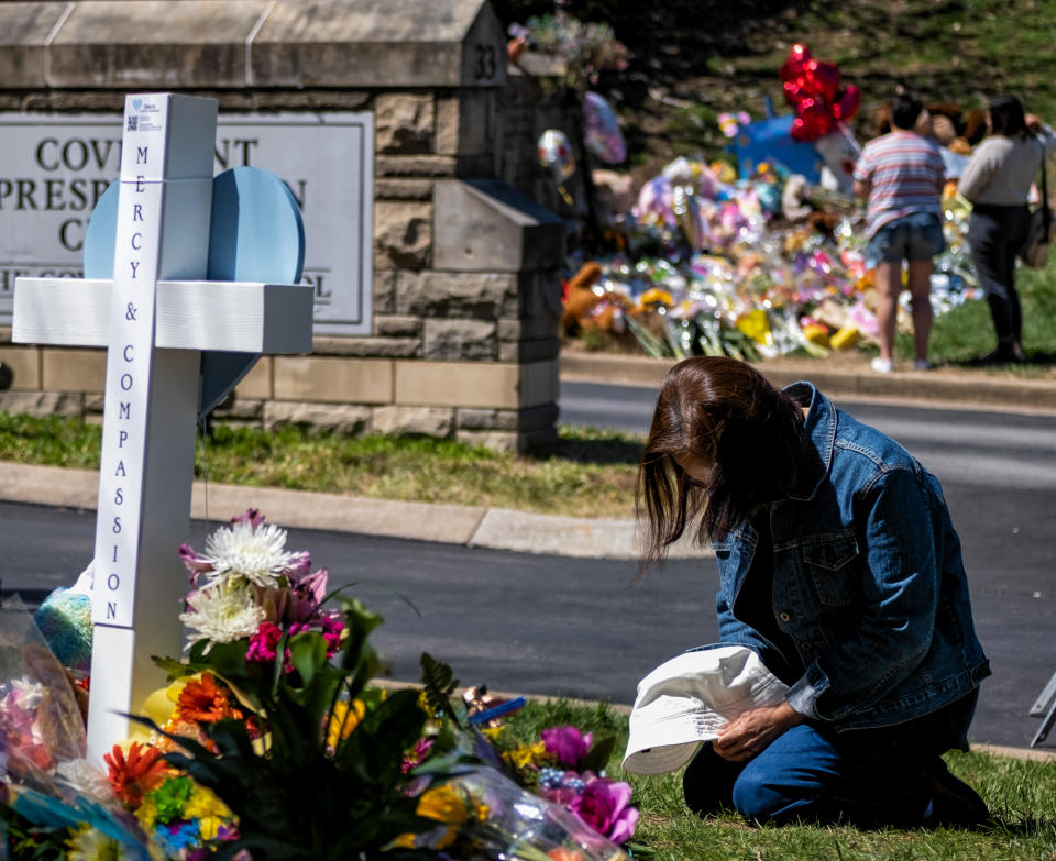 NASHVILLE, TN - MARCH 29: A woman prays at a makeshift memorial for those killed in a mass shooting at the entrance of The Covenant School on March 29, 2023 in Nashville, Tennessee. Three students and three adults were killed by the 28-year-old shooter on Monday.  (Photo by Seth Herald/Getty Images)