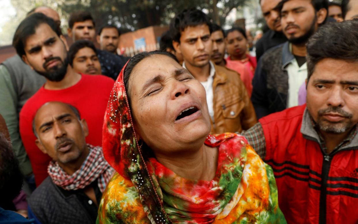 Relatives of the victims gathered outside a hospital mortuary  - REUTERS