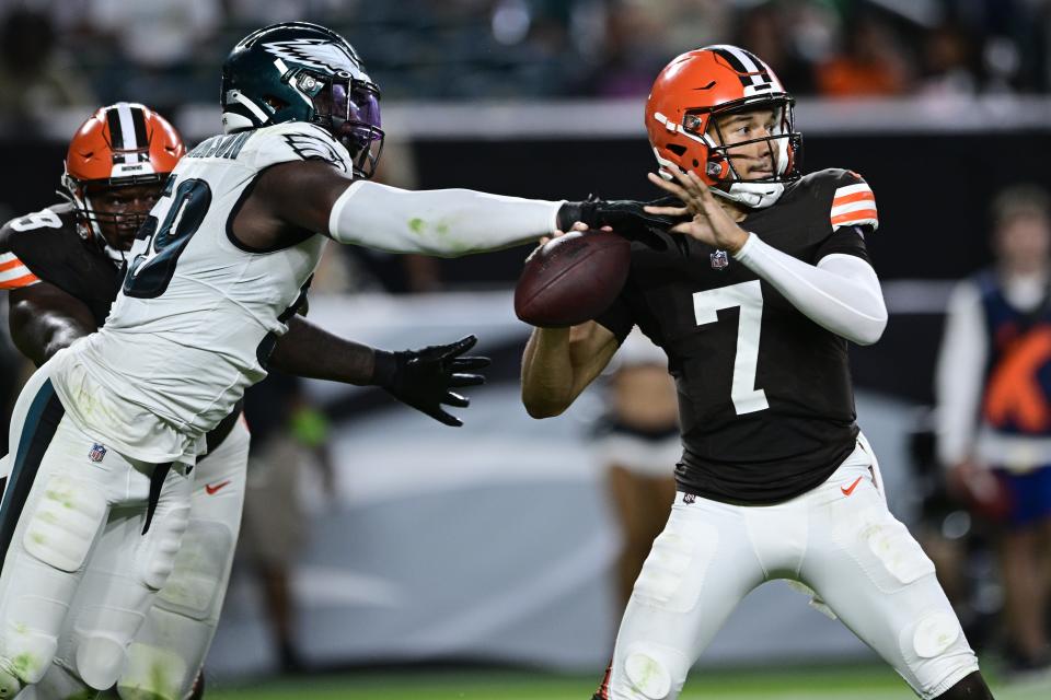 Cleveland Browns quarterback Kellen Mond (7) avoids a tackle by Philadelphia Eagles defensive end Janarius Robinson (59) during the second half of an NFL preseason football game Thursday, Aug. 17, 2023, in Philadelphia. (AP Photo/Derik Hamilton)