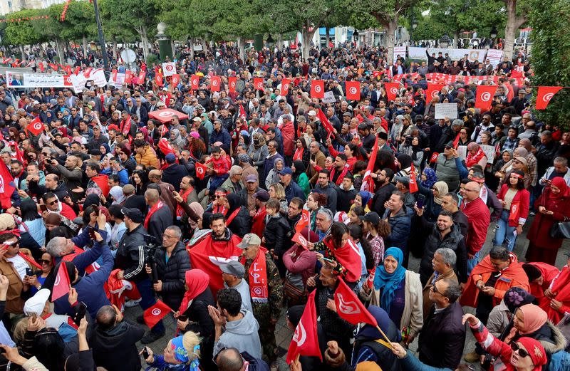 FILE PHOTO: Supporters of Tunisia's President Kais Saied carry national flags