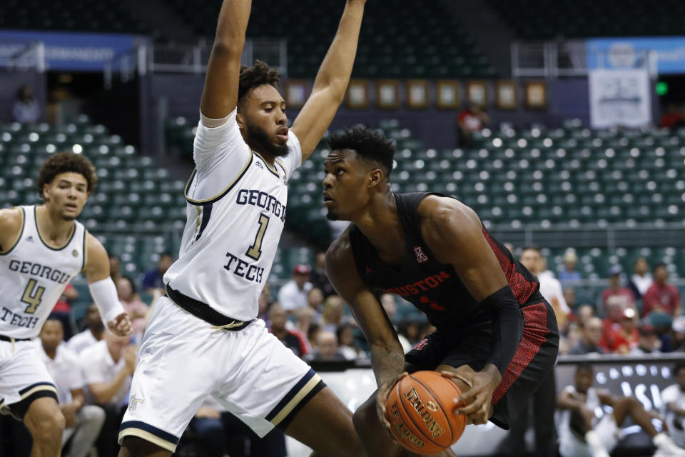 Georgia Tech forward James Banks III guards Houston center Chris Harris Jr., right, during the first half of an NCAA college basketball game Monday, Dec. 23, 2019, in Honolulu. (AP Photo/Marco Garcia)