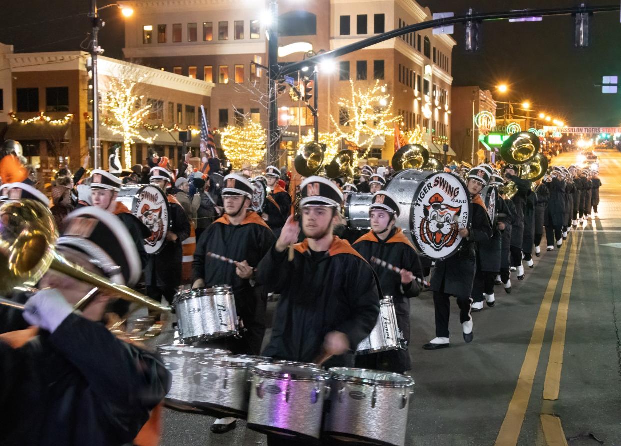 The Massillon Tiger Swing Band marches through town Sunday during the victory parade for the football team's 2023 state championship.