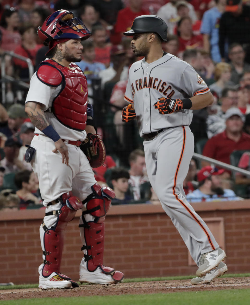 St. Louis Cardinals catcher Yadier Molina waits as San Francisco Giants' LaMonte Wade Jr crosses home plate after hitting a three-run home run during the fifth inning of a baseball game Friday, July 16, 2021, in St. Louis. (AP Photo/Tom Gannam)