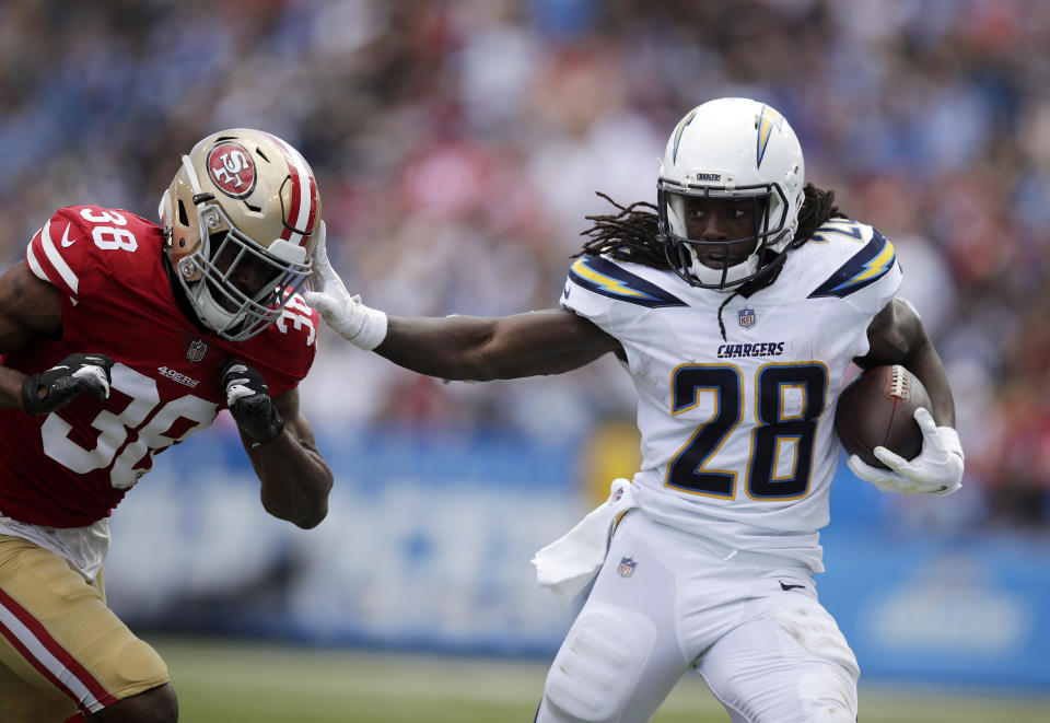 <p>Los Angeles Chargers running back Melvin Gordon, right, fends off San Francisco 49ers defensive back Antone Exum as he runs the ball during the first half of an NFL football game, Sunday, Sept. 30, 2018, in Carson, Calif. (AP Photo/Jae Hong) </p>