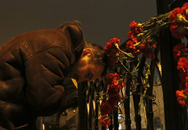 A man grieves outside the Volgograd main railway station in Volgograd, Russia early Monday, Dec. 30, 2013. A bomb blast tore through a trolleybus in the city of Volgograd on Monday morning, killing at least 10 people a day after a suicide bombing that killed at least 17 at the city's main railway station. Volgograd is about 650 kilometers (400 miles) northeast of Sochi, where the Olympics are to be held. (AP Photo/Denis Tyrin)