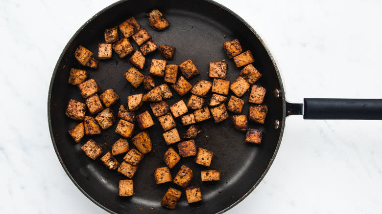 Jerk tofu frying in pan