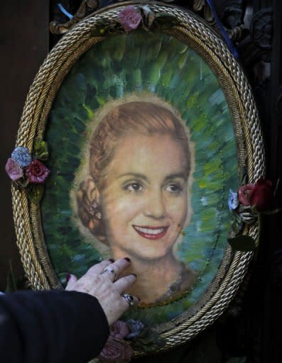 A woman touchs a portrait of Eva Duarte de Peron at the Duarte's Family vault where rest the remains of Eva Duarte de Peron on the 60th anniversary of her death in Buenos Aires