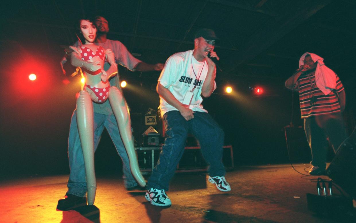Eminem (center) is flanked by Mr. Gill of the Levels (left with doll) and Bizarre on Sept. 26, 1997, at the Palladium in Roseville, Mich.