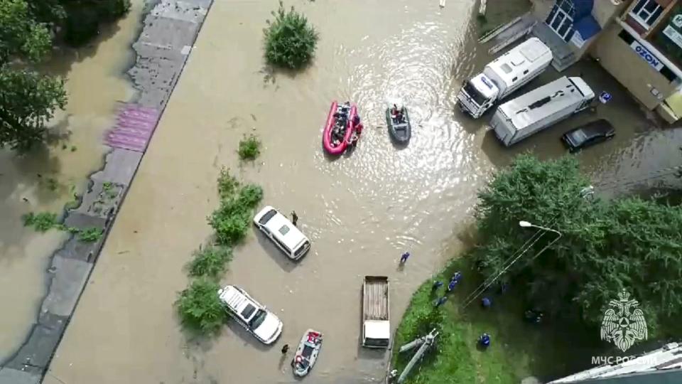 In this photo released by Russian Emergency Ministry Press Service on Sunday, Aug. 13, 2023, Emergency service workers use their boats as they give assistance in a flooded village in Primorye region, Russia's Far East after heavy downpours flooded villages in the region in the aftermath of Typhoon Khanun. Russian emergency officials say over 2,000 people have been evacuated from flooded areas of the Primorye region in the country's Far East. (Russian Emergency Ministry Press Service via AP)