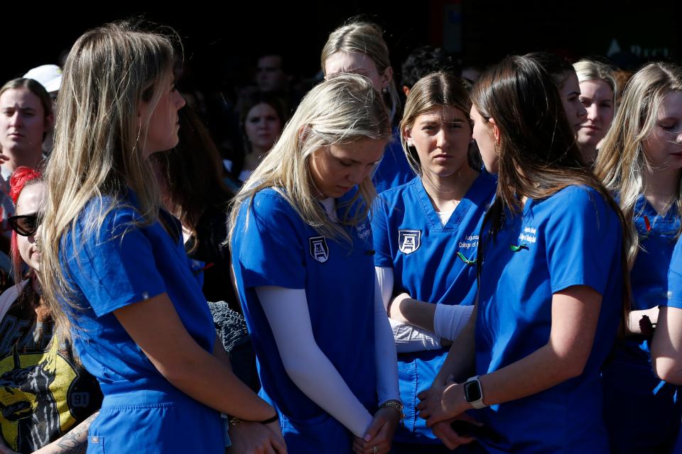 Students arrive at a vigil for Laken Riley who was murdered on campus on Feb. 22, and Wyatt Banks, a UGA freshman who died by suicide on campus on Feb. 21., at the UGA Tate plaza on Monday, Feb. 26, 2024.