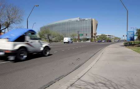 A truck passes the location where a woman pedestrian was struck and killed by an Uber self-driving sport utility vehicle in Tempe, Arizona, U.S. March 19, 2018. REUTERS/Rick Scuteri