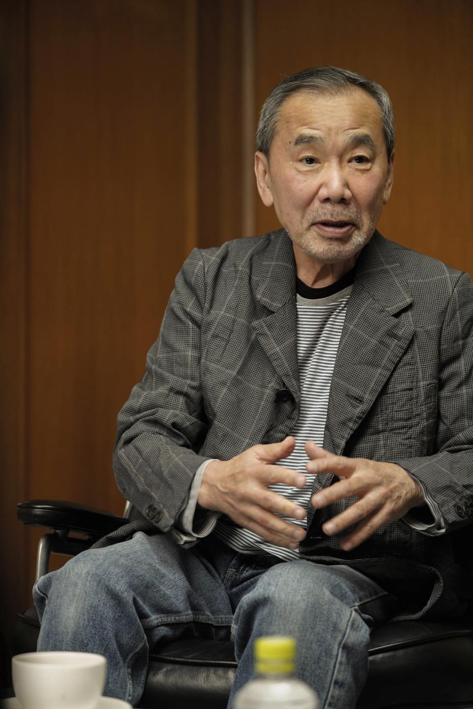 In this photo released by Shinchosha, Haruki Murakami speaks on March 17, 2023, at Shinchosha in Tokyo. Murakami wrote a story of a walled city when he was fresh off his debut. More than four decades later, as a seasoned and acclaimed novelist, he gave it a new life as “The City and Its Uncertain Walls.” (Kenji Sugano/Shinchosha via AP)