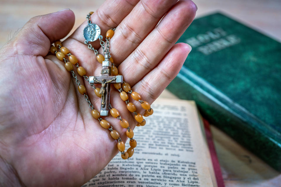 Hand holding a rosary