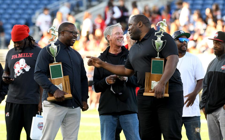 Members of the championship 1997 and 1998 McKinley Bulldogs, including Mike Doss, coach Thom McDaniels and Kenny Peterson, were honored, Friday, Sept 15, 2023, in Canton.
