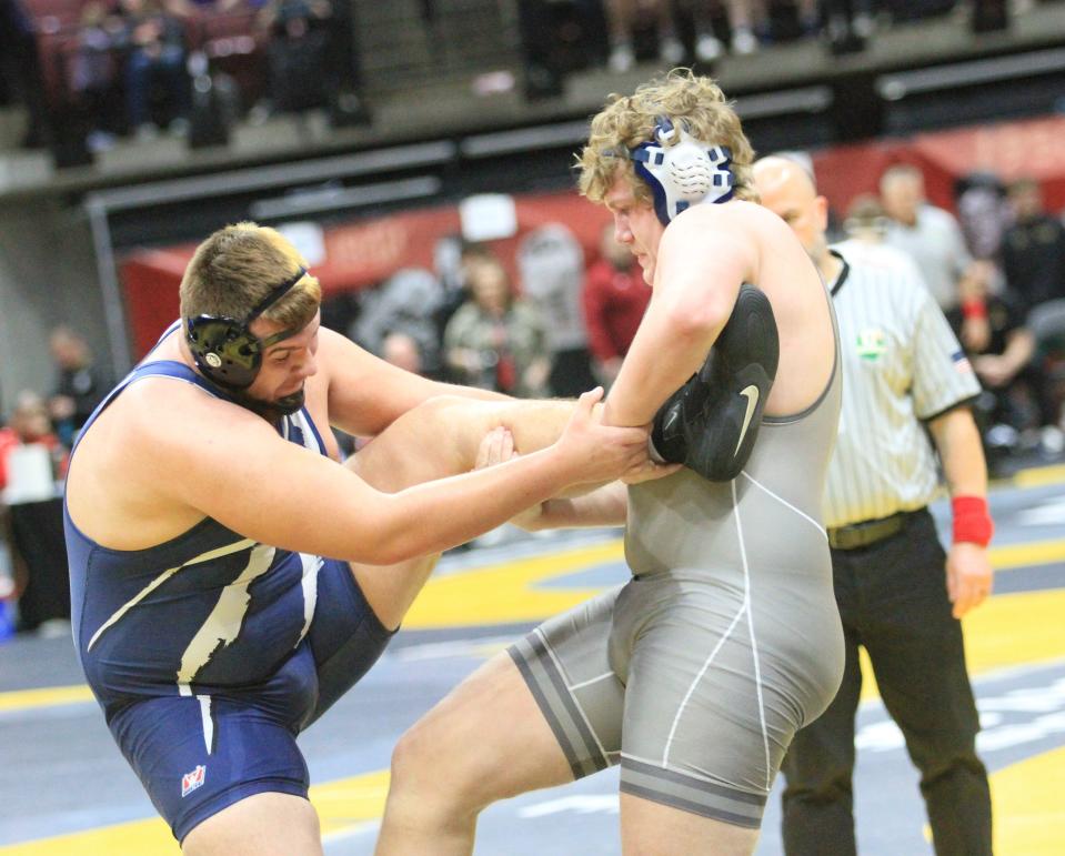 Granville's Ian Rutherford wrestles Napoleon's Isaac Lehman in a heavyweight match during the Division II state championships at Ohio State's Schottenstein Center on Saturday, March 9, 2024.