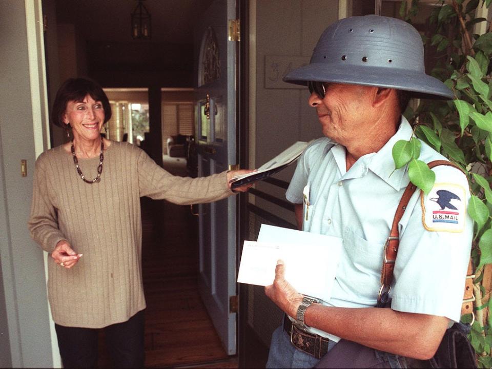A mailman wears a helmet in 1996