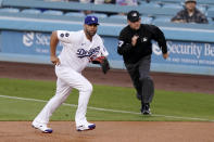 Los Angeles Dodgers first baseman Albert Pujols, left, runs to cover first as Arizona Diamondbacks' Josh Rojas hits a single while first base umpire Dan Merzel watches during the first inning of a baseball game Monday, May 17, 2021, in Los Angeles. (AP Photo/Mark J. Terrill)