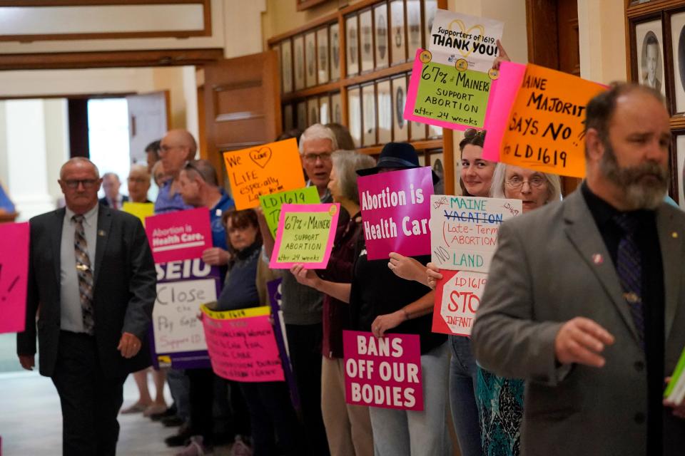 Protesters line the hallway leading to the House Chamber, Wednesday, June 21, 2023, at the State House in August, Maine. The Legislature is working to wrap up the current session before summer break.