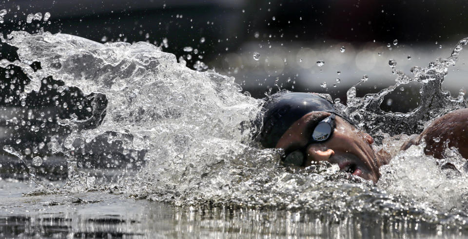 Gold-medalist Oussama Mellouli, from Tunisia, competes in the men's 10-kilometer swimming marathon in Hyde Park at the 2012 Summer Olympics Friday, Aug. 10, 2012, in London. (AP Photo/Charlie Riedel)