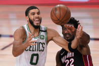 Boston Celtics' Jayson Tatum (0) and Miami Heat's Jimmy Butler (22) battle for a rebound during the second half of an NBA conference final playoff basketball game Sunday, Sept. 27, 2020, in Lake Buena Vista, Fla. (AP Photo/Mark J. Terrill)
