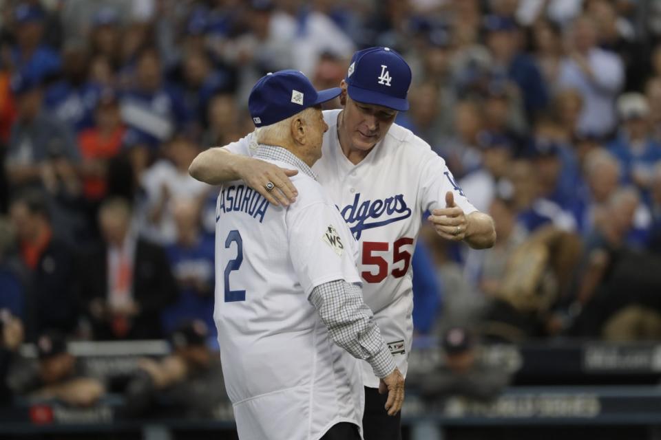 Tommy Lasorda and Orel Hershiser hug after each threw out a ceremonial first pitch before Game 6 of the 2017 World Series