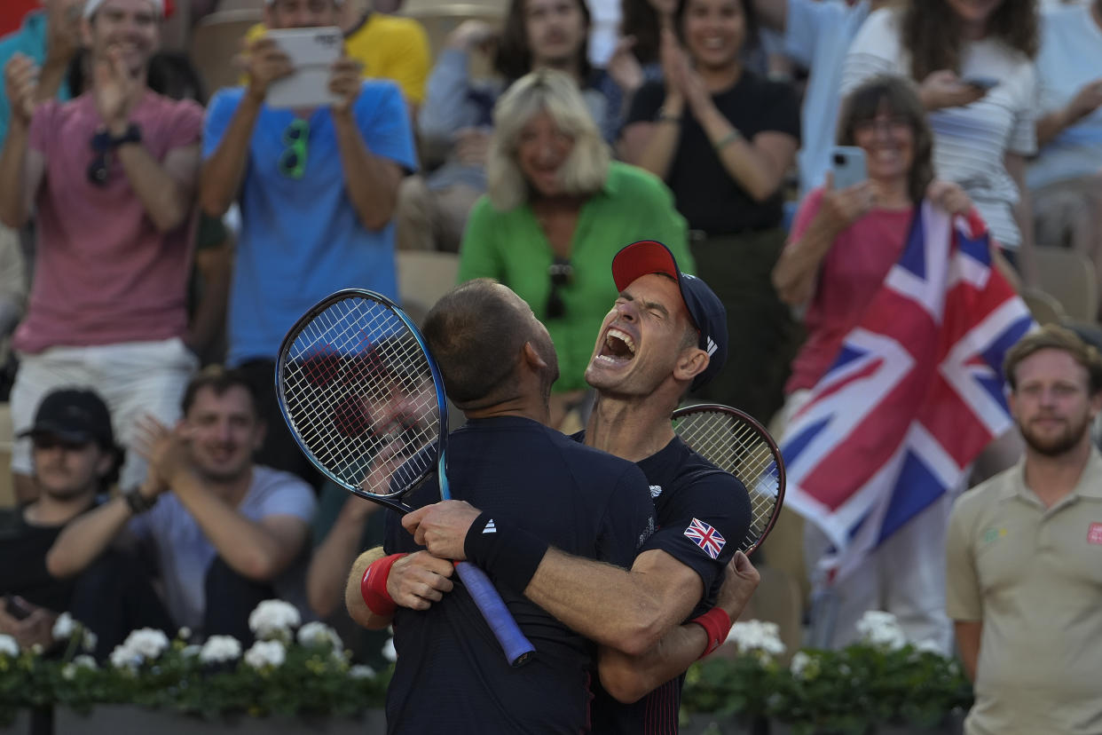 Andy Murray and Daniel Evans of Britain celebrate after defeating Kei Nishikori and Toro Daniel of Japan in the men's doubles tennis competition.