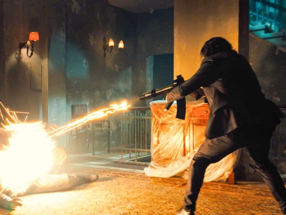 Keanu Reeves as John Wick killing someone with a dragon's breath shotgun.