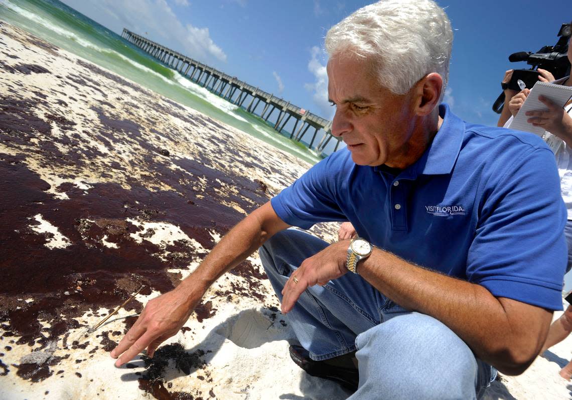 Florida Governor Charlie Crist inspects the oil that washed ashore at Casino Beach overnight before checking out the the relief work efforts staged at Pensacola Beach on Wednesday morning, June 23, 2010.