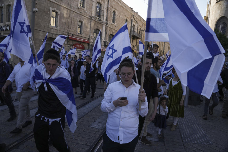 Israeli right wing activists with Israeli flags gather for a march in Jerusalem, Wednesday, April 20, 2022. Police prevented hundreds of ultra-nationalist Israelis from marching around predominantly Palestinian areas of Jerusalem's Old City. The event planned for Wednesday was similar to one that served as one of the triggers of last year's Israel-Gaza war. (AP Photo/Maya Alleruzzo)