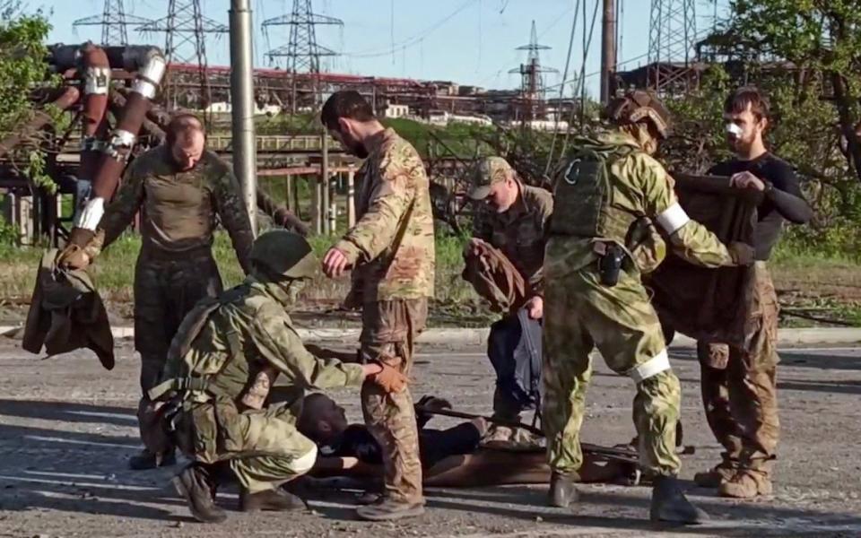 A screengrab from a video released by the Russian Defence Ministry shows Ukrainian soldiers being searched by pro-Russian military personnel after leaving the besieged Azovstal steel plant in Ukraine's port city of Mariupol - Russian Defence Ministry/AFP