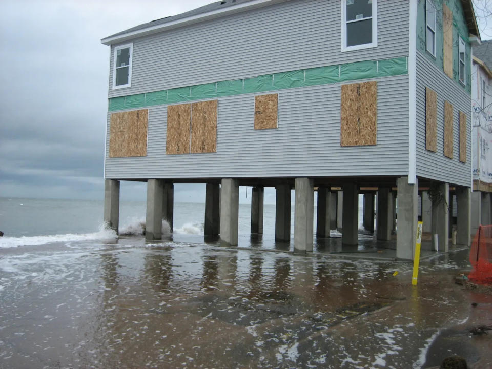  An East Haven home partially rebuilt after tropical storm Irene in 2011 is surrounded by stormwaters from storm Sandy a year later. Forecasters predict a high likelihood of more storms like this or worse this hurricane season, partly due to impacts from climate change. (Jan Ellen Spiegell/CT Mirror)