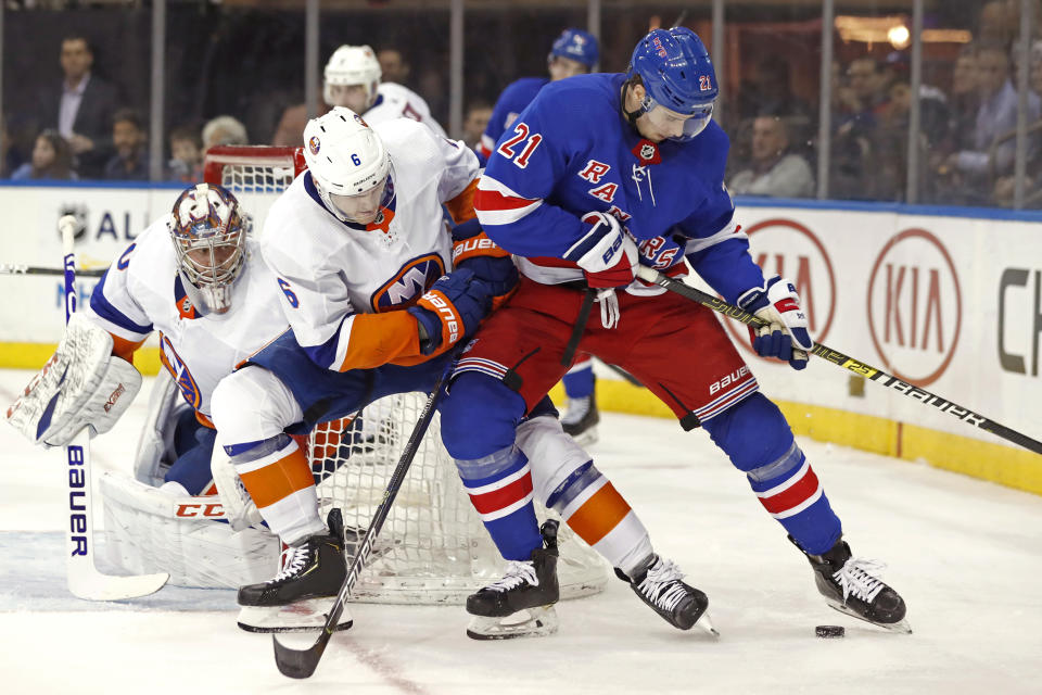 New York Islanders defenseman Ryan Pulock (6) defends New York Rangers center Brett Howden (21) in front of Islanders goaltender Semyon Varlamov (40) during the second period of an NHL hockey game, Monday, Jan. 13, 2020, in New York. (AP Photo/Kathy Willens)