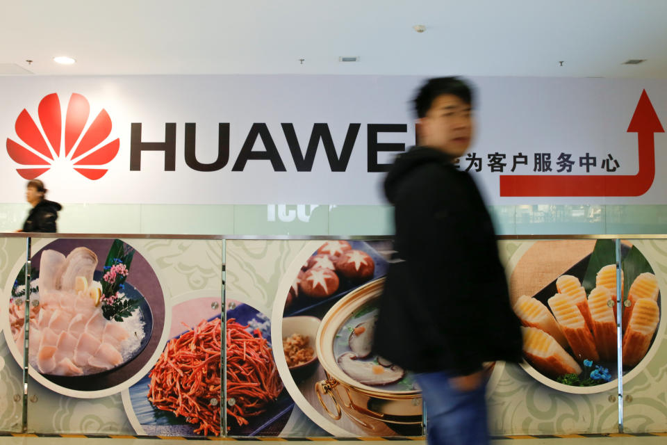 A man walks past a Huawei sign in a mall in Beijing, China, January 29, 2019.   REUTERS/Thomas Peter