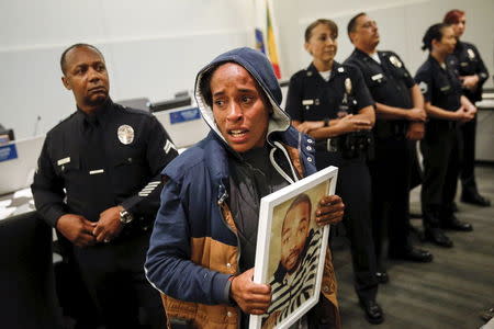 A woman protests the death of Ezell Ford during a meeting of the Los Angeles Police Commission in Los Angeles, California June 9, 2015. REUTERS/Patrick T. Fallon