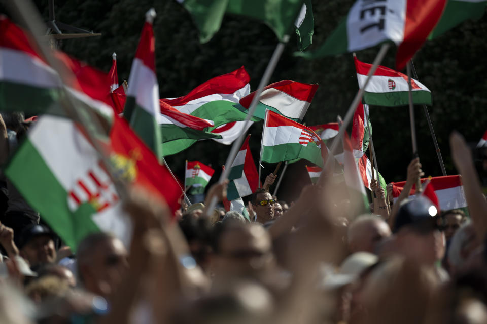 People wave the Hungarian national flag during Péter Magyar's speech at a campaign rally in the rural city of Debrecen, Hungary, on Sunday, May 5, 2024. Magyar, whose TISZA party is running in European Union elections, has managed to mobilize large crowds of supporters on a campaign tour of Hungary's heartland, a rarity for an Orbán opponent. (AP Photo/Denes Erdos)