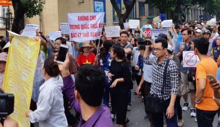 FILE PHOTO: Protesters hold a banner which reads