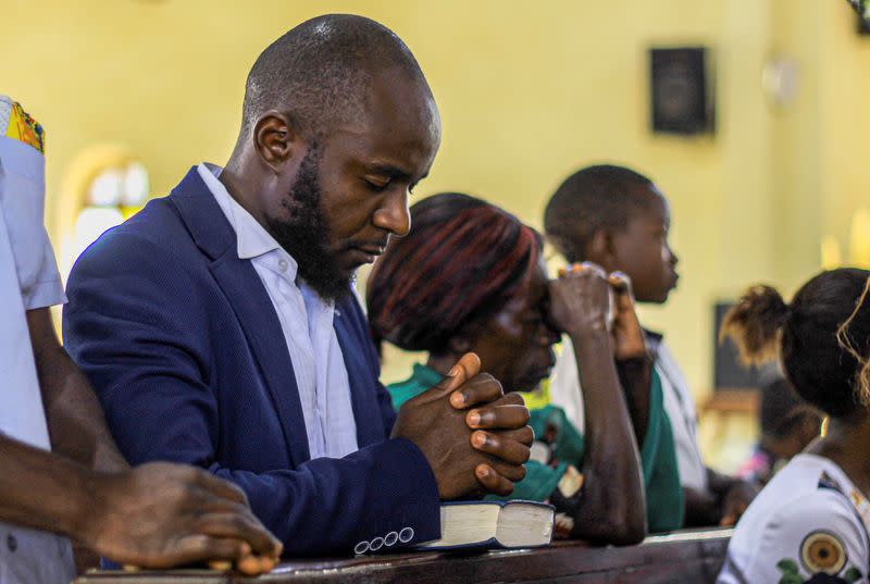 Faithfuls pray inside the Emmanuel-Butsili Catholic Parish, in Beni