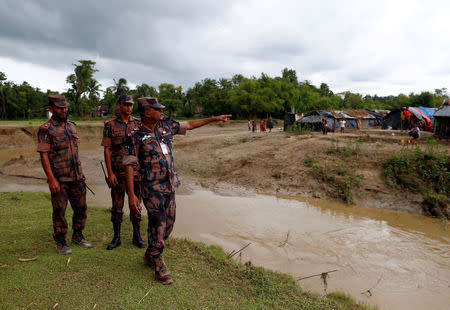 Lieutenant Colonel Monzurul Hassan Khan, a commanding officer of the Border Guards Bangladesh (BGB), speaks as Rohingya refugees stand outside their temporary shelters at no man's land between Bangladesh-Myanmar border, in Cox's Bazar, Bangladesh September 9, 2017. REUTERS/Danish Siddiqui