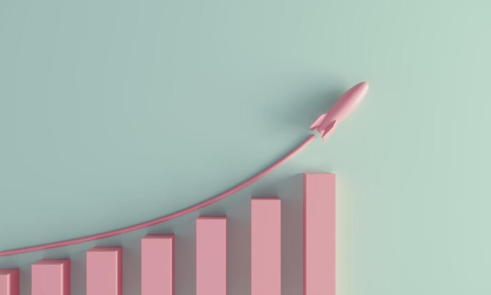 A pink rocket ship flying above a rising bar graph.